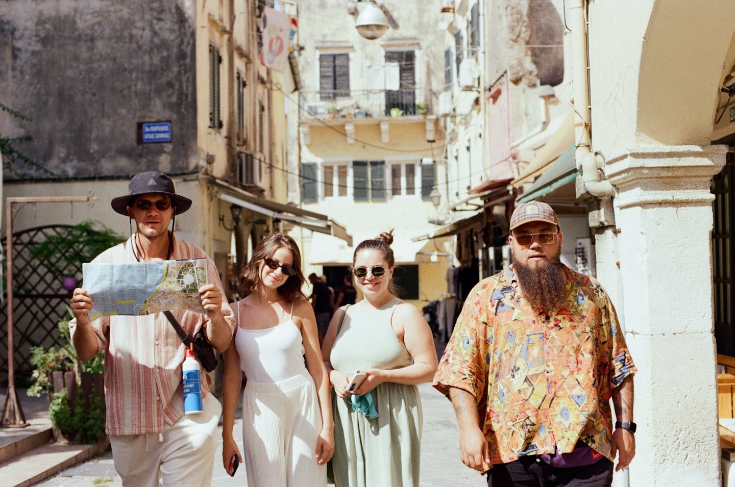 Travelers exploring a sunlit historic European street.